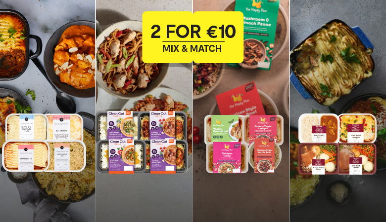 Promotional banner for a '2 for €10 Mix & Match' offer featuring various ready meals on a grey background with images of plated dishes. The yellow box in the center displays the offer text in bold. Featured products include brands such as Clean Cut Meals, The Happy Pear, and SuperValu own-brand ready meals like lasagnas, curries, and shepherd's pies.