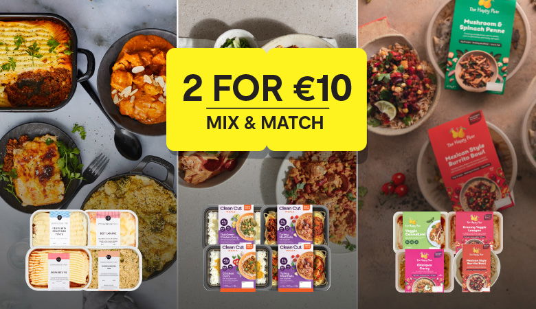 Promotional banner for a '2 for €10 Mix & Match' offer featuring various ready meals on a grey background with images of plated dishes. The yellow box in the center displays the offer text in bold. Featured products include brands such as Clean Cut Meals, The Happy Pear, and SuperValu own-brand ready meals like lasagnas, curries, and shepherd's pies.