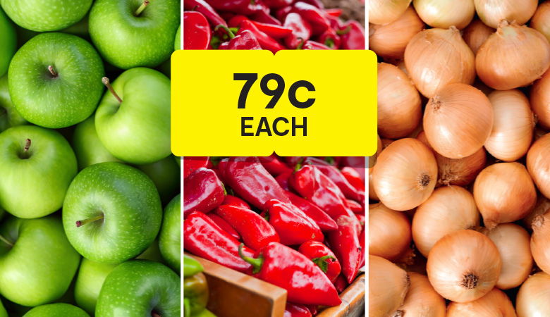 A close-up photo of a produce display divided into three sections. The left section shows a pile of green apples. The middle section displays a crate of bright red peppers. The right section is filled with brown onions. A large yellow price tag in the middle reads "79c EACH."