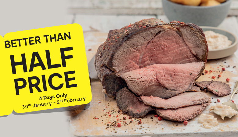 A close-up photo of a roasted beef joint with a few slices cut off. The beef is resting on a wooden board sprinkled with peppercorns. A yellow tag in the foreground reads "Better than Half Price" and "4 Days Only" with the dates "30th January - 2nd February" printed below.