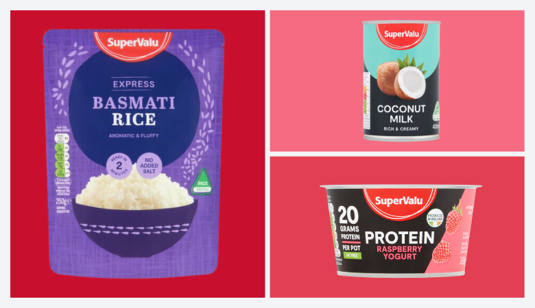 Promotional image showcasing three SuperValu food products on a vibrant split background. On the left, a purple package of SuperValu Express Basmati Rice labeled 'Aromatic & Fluffy' and 'Ready in 2 Minutes.' Top right, a can of SuperValu Coconut Milk described as 'Rich & Creamy,' with an image of a coconut on the label. Bottom right, a container of SuperValu Protein Raspberry Yogurt, boasting '20 grams protein per pot' and featuring fresh raspberries on the packaging. Each product is distinctly highlighted against red and pink backgrounds.