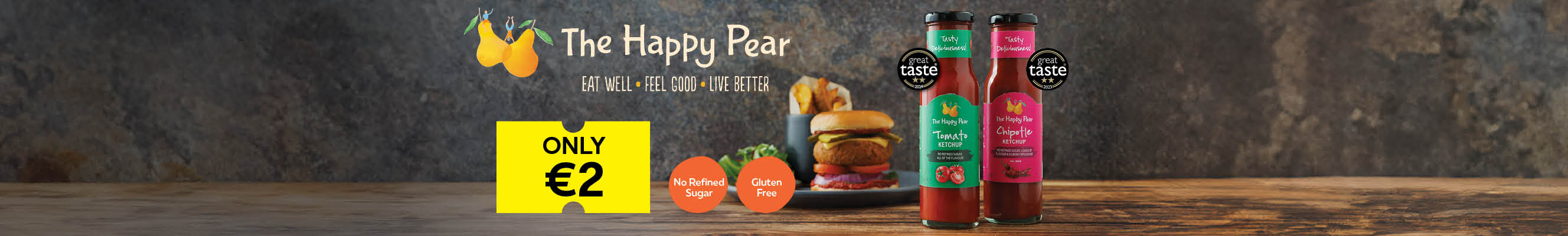 A collage of photos showcasing The Happy Pear products including a burger, a variety of sauces, and a yellow price tag that says "ONLY €2." The text "The Happy Pear" is displayed in large text with the tagline "Eat Well, Feel Good, Live Better."