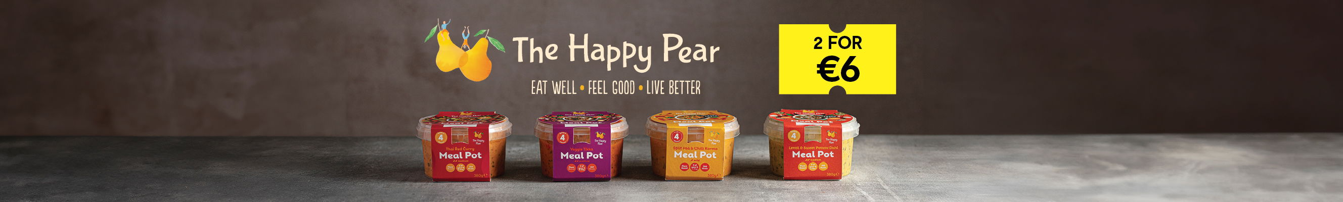 Promotional image for The Happy Pear Meal Pots featuring four different flavors of meal pots displayed on a rustic gray surface with a dark textured background. The Happy Pear logo, including two yellow pears with green leaves, is prominently displayed along with the tagline 'EAT WELL • FEEL GOOD • LIVE BETTER.' A yellow tag on the right reads '2 FOR €6' in bold black text, highlighting the special offer.