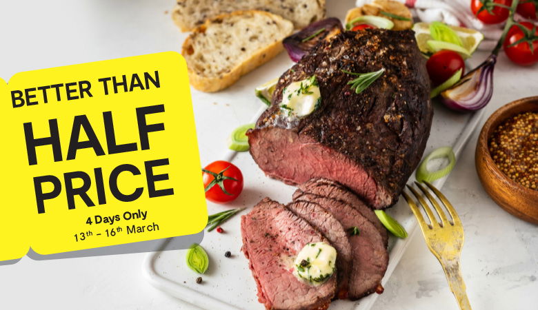 Promotional image featuring a perfectly cooked roast beef. A yellow tag on the left corner prominently reads 'better than half price' in bold black text, emphasizing the discount offer. 