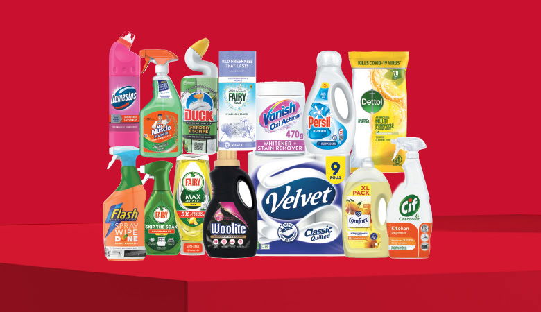 A promotional image showcasing various household cleaning and laundry products against a red backdrop.