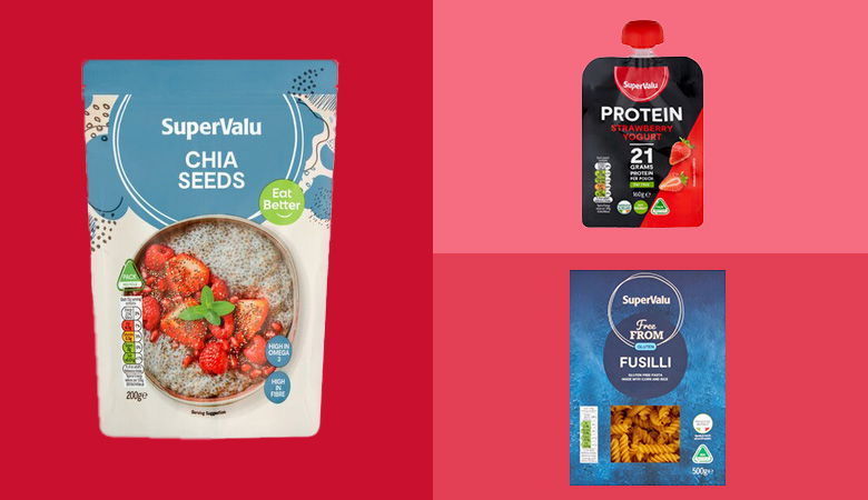 Promotional image showcasing three SuperValu food products on a vibrant split background. On the left, a purple package of SuperValu Express Basmati Rice labeled 'Aromatic & Fluffy' and 'Ready in 2 Minutes.' Top right, a can of SuperValu Coconut Milk described as 'Rich & Creamy,' with an image of a coconut on the label. Bottom right, a container of SuperValu Protein Raspberry Yogurt, boasting '20 grams protein per pot' and featuring fresh raspberries on the packaging. Each product is distinctly highlighted against red and pink backgrounds.