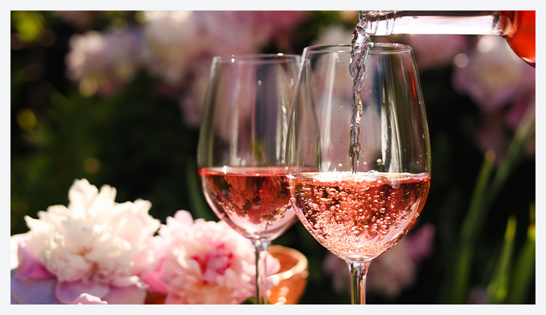 Rosé Season, rosé wine being poured into two glasses
