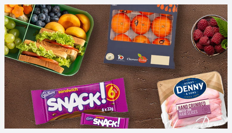 Selection of snacks, bread, cheese, ham, and drinks for school lunches.