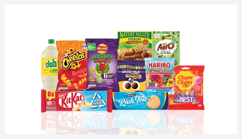 A promotional image showcasing a variety of snack foods and drinks against a red backdrop.