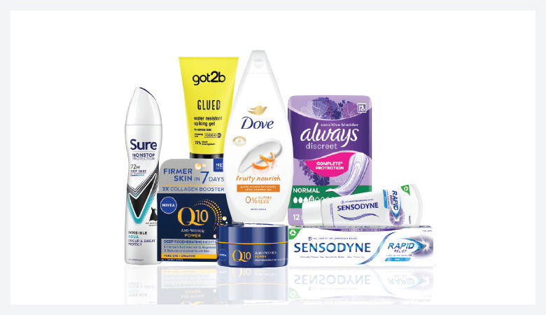 A promotional image showcasing various personal care products against a red backdrop.