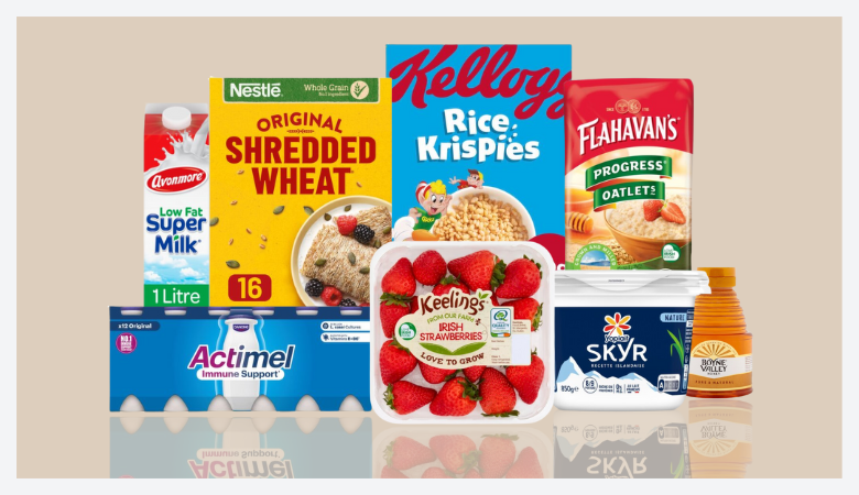 Assorted breakfast foods including cereal, yogurt, berries, and milk.