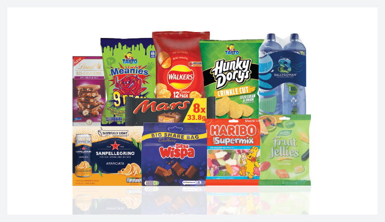 A promotional image showcasing a variety of snack foods and drinks against a red backdrop.