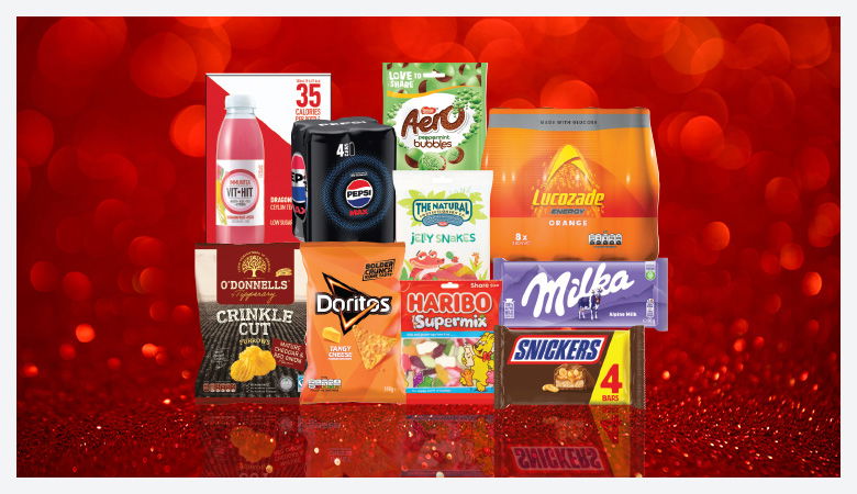A promotional image showcasing a variety of snack foods and drinks against a red backdrop.