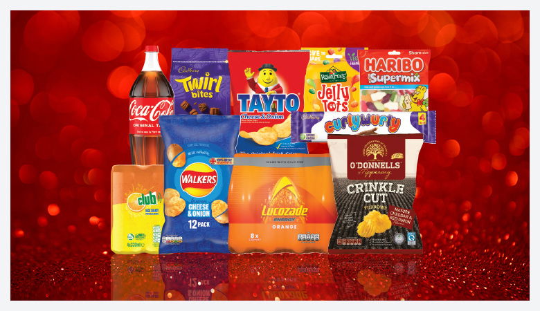 A promotional image showcasing a variety of snack foods and drinks against a red backdrop.