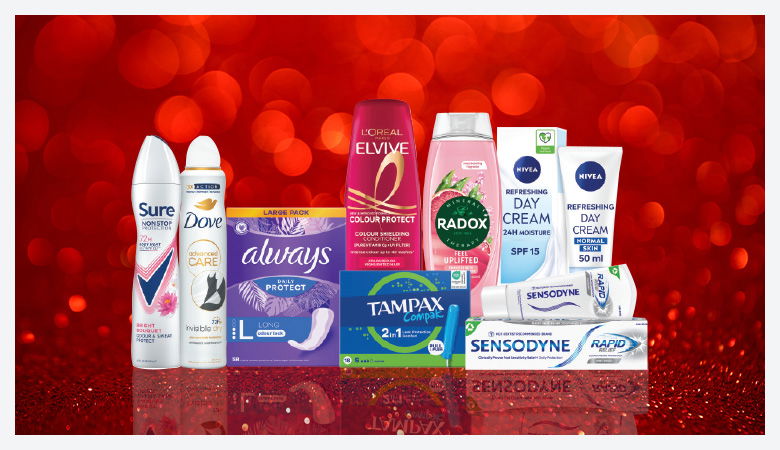 A promotional image showcasing various personal care products against a red backdrop.
