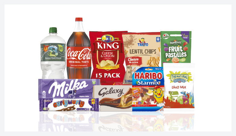 A promotional image showcasing a variety of snack foods and drinks against a red backdrop.