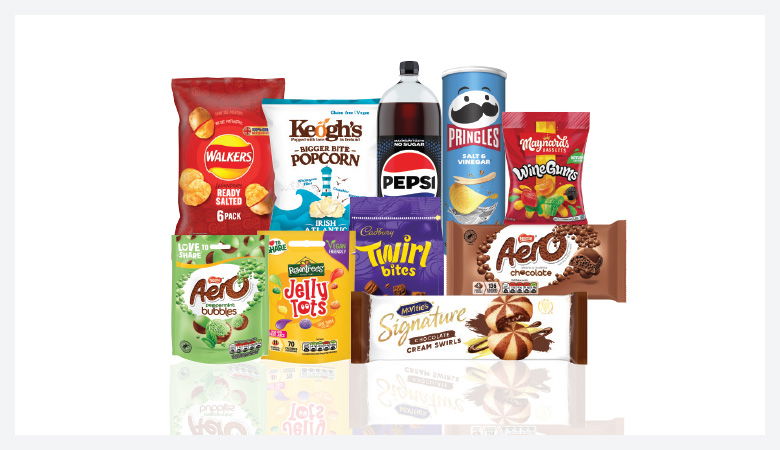 A promotional image showcasing a variety of snack foods and drinks against a red backdrop.