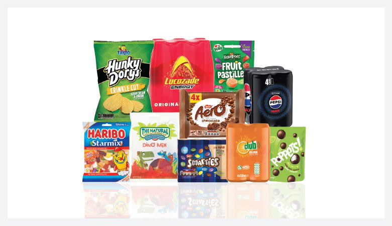 A promotional image showcasing a variety of snack foods and drinks against a red backdrop.