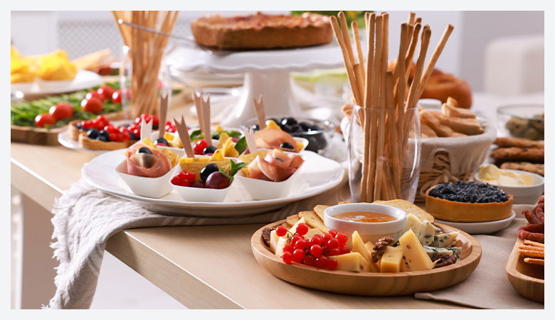 a table with a selection of meats, salads and chesses