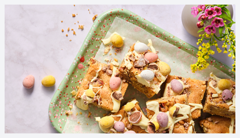 a table full of baked good, from cupcakes, to maderia and hot cross buns