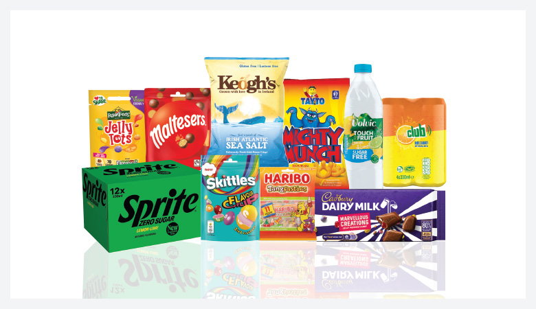 A promotional image showcasing a variety of snack foods and drinks against a red backdrop.